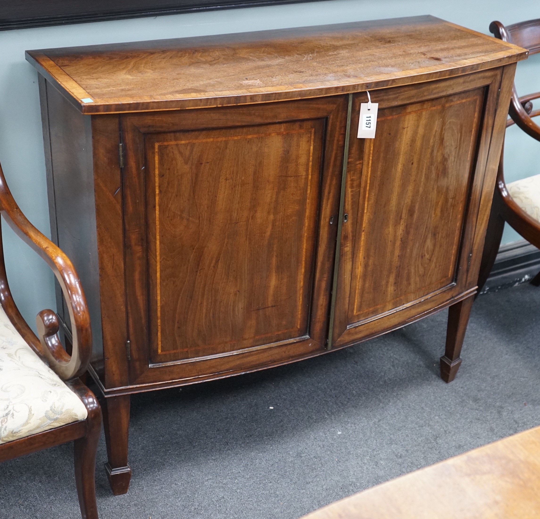 A George III mahogany and banded bowfront side cabinet with panelled doors on square tapering legs, width 103cm, depth 42cm, height 90cm